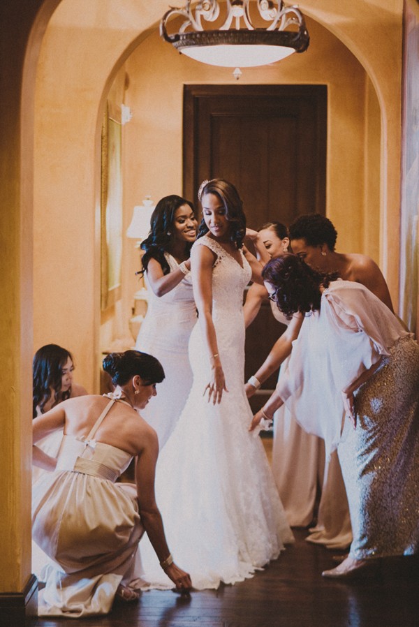 Bridesmaids fixing wedding gown